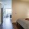 well lit bedroom with two closets adjacent to kitchen
