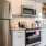 kitchen wall, brightly lit with stainless steel appliances