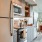 kitchen wall, brightly lit with stainless steel appliances