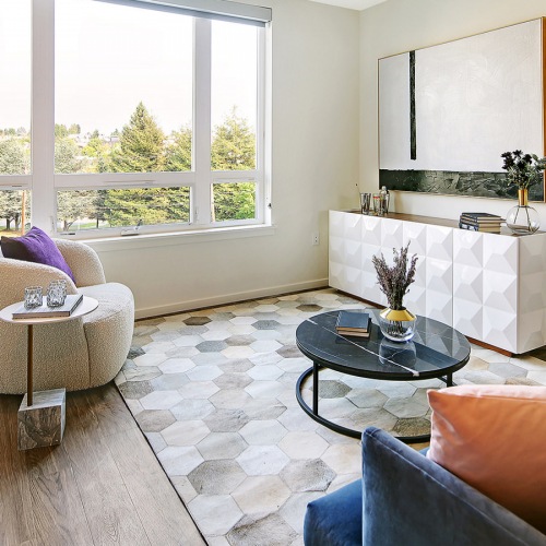 spacious and well lit living room with large window