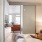 sliding, frosted glass doors in bedroom open to bright living room