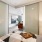 cozy bedroom with frosted glass doors opening to living room
