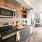 kitchen wall adjacent to brightly lit dining area and living room
